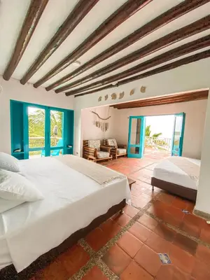 a large bedroom with two beds in a room at Casa Tinti in Tintipan Island