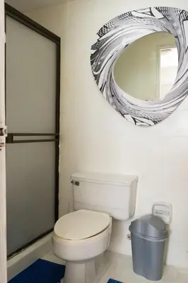 a bathroom with a toilet and a mirror at Apt frente al Mar 10 min a pie Centro Histórico in Cartagena de Indias