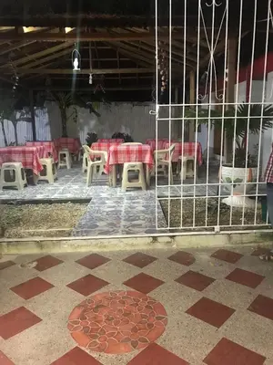 a restaurant with a table and chairs in a room at Cabaña La Fortaleza in Tolú