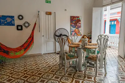 a dining room with a table and chairs at Hostal Badillo SV in Cartagena de Indias
