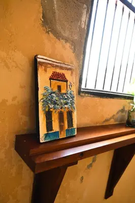 a picture of a house sitting on a window sill at Casa de la Cruz Centro Historico in Cartagena de Indias