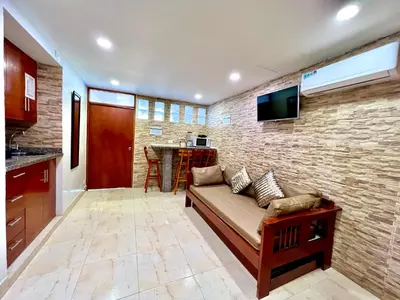 a living room with a couch and a brick wall at PyEnsa Cartagena in Cartagena de Indias
