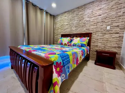 a bedroom with a bed in a brick wall at PyEnsa Cartagena in Cartagena de Indias