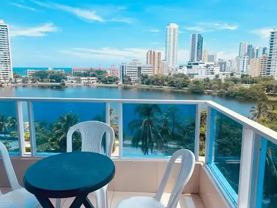 a balcony with a table and chairs and a view of the city at PyEnsa Cartagena in Cartagena de Indias
