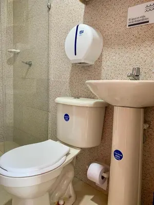 a bathroom with a toilet and a sink at PyEnsa Cartagena in Cartagena de Indias
