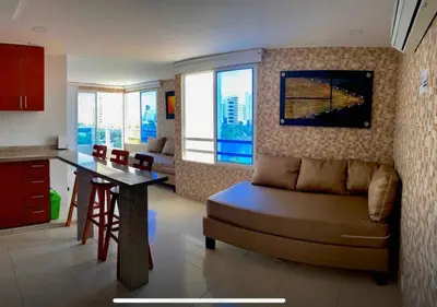 a living room with a couch and a table in a kitchen at PyEnsa Cartagena in Cartagena de Indias