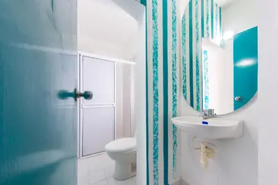 a bathroom with a sink and a toilet and a mirror at Hotel Ayenda Cartagena Blue 1804 in Cartagena de Indias