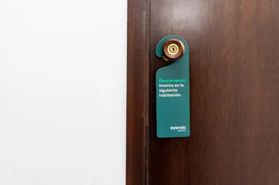 a doorhandle with a sign on a wooden door at Hotel Ayenda Cartagena Blue 1804 in Cartagena de Indias