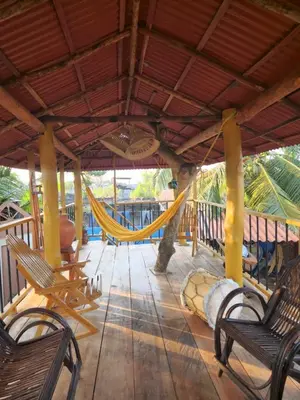 a porch with a hammock and a playground at Alojamiento Bityn in Paso Nuevo