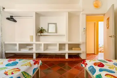 a room with a white shelf and a bed at JUNTO AL MAR Y EL MANGLAR in Cartagena de Indias