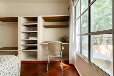a bedroom with a desk and a window and a chair at JUNTO AL MAR Y EL MANGLAR in Cartagena de Indias