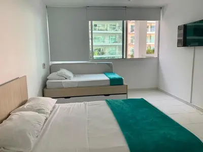 a bedroom with a bed and a couch in it at Cartagena Morros 3 Playa in Cartagena de Indias