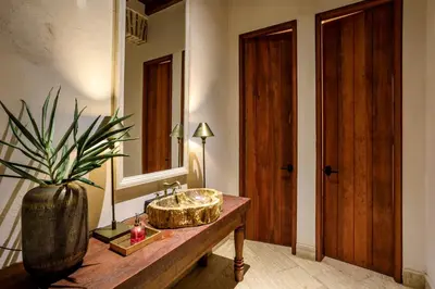 a bathroom with a sink and a large mirror at Eurostars Marqués de Villalta in Cartagena de Indias