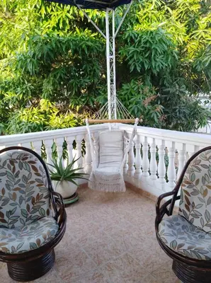 two chairs and a hammock on a porch at Casa Hotel Manga Mar in Cartagena de Indias