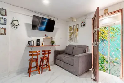 a living room with a couch and two stools at Casa Rachel in Cartagena de Indias
