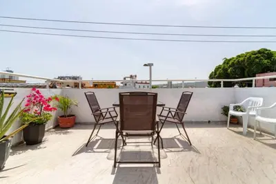 a patio with chairs and a table on a roof at Casa Rachel in Cartagena de Indias