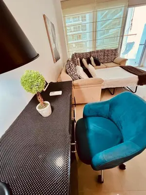 a living room with a blue chair and a couch at MORROS EPIC luxury in Cartagena de Indias
