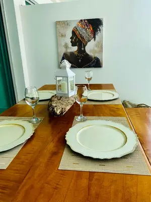 a wooden table with plates and wine glasses on it at MORROS EPIC luxury in Cartagena de Indias