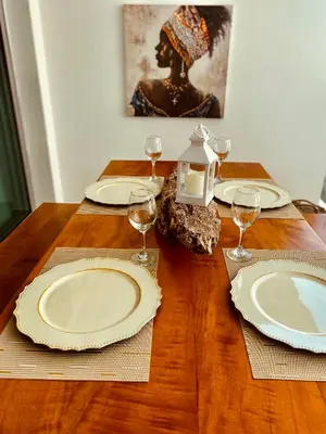 a wooden table with plates and wine glasses on it at MORROS EPIC luxury in Cartagena de Indias