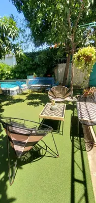 a patio with a table and chairs and a table at Ritacuba House Boutique in Santa Marta