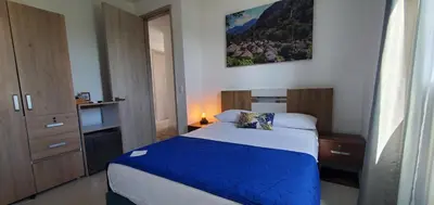 a bedroom with a bed with a blue blanket at Ritacuba House Boutique in Santa Marta