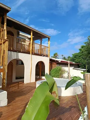 a patio of a house with a wooden deck at Paraíso Natural Ecohotel in San Bernardo del Viento