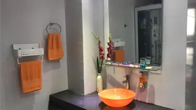 a bathroom with an orange bowl on a counter at APARTMENT WHITE BOCAGRANDE - Los Delfines in Cartagena de Indias