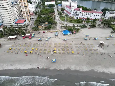 an aerial view of a beach with tables and umbrellas at Modern 1BR WiFi Breathtaking Oceanviews by Huespedia in Cartagena de Indias