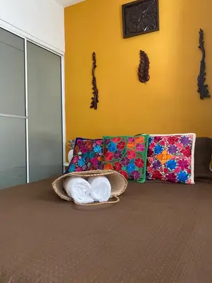 a living room with a couch with towels on it at Casa San Juan in Cartagena de Indias