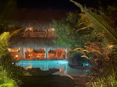 a resort with a swimming pool at night at Eco Xata in Santa Veronica