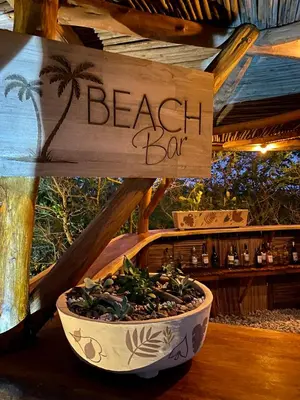a sign that says beach bar with a potted plant at Eco Xata in Santa Veronica