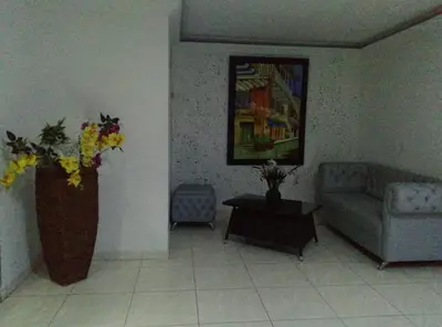 a living room with a couch and a vase of flowers at Comodo Apartamento en Bocagrande Cartagena 801B in Cartagena de Indias
