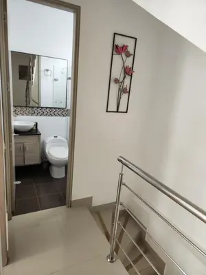 a bathroom with a toilet and a sink and a mirror at Costa Serena Casa 3 in Coveñas
