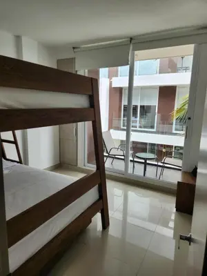 a bedroom with a bunk bed and a balcony at Costa Serena Casa 3 in Coveñas