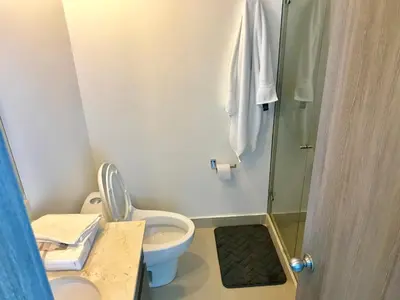 a bathroom with a toilet and a shower at 22nd flr Spectacular Seaview Morros City Bocagrande in Cartagena de Indias