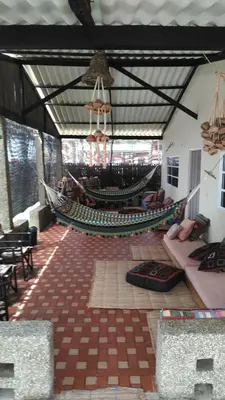 a room with a hammock in the middle of a room at Zéfiro Hostal in San Bernardo del Viento
