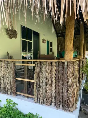 a view of a house with a table and a tree at Zéfiro Hostal in San Bernardo del Viento