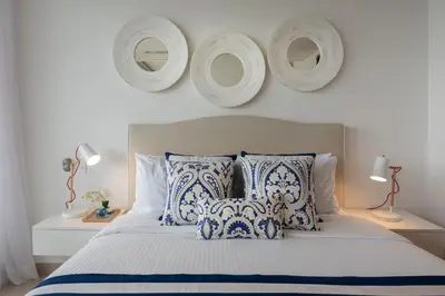 a bedroom with a bed with blue and white pillows at Classy 1 BR, Pool, Gym near Downtown Cartagena by Huespedia in Cartagena de Indias