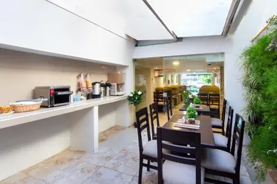 a dining room with a table and chairs at Hotel Avexi Suites By GEH Suites in Cartagena de Indias