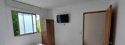 a room with a window and a television on the wall at Apartamento la Isla 1-Coveñas in Coveñas
