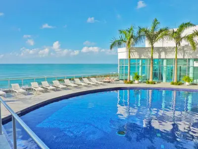 a swimming pool with a view of the ocean at Apartamentos Palmetto - Frente al Mar in Cartagena de Indias