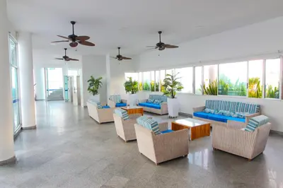 a living room with couches and tables and windows at Apartamentos Palmetto - Frente al Mar in Cartagena de Indias