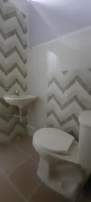 a bathroom with a white toilet and a sink at Apartamentos LUISA in Coveñas