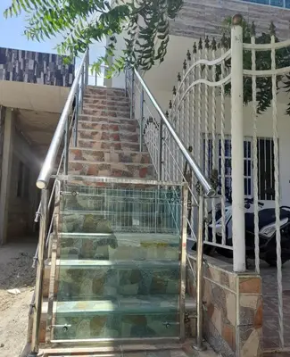 a set of stairs with a metal railing at Apartamentos LUISA in Coveñas
