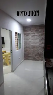 an empty room with a door and a brick wall at Apartamentos LUISA in Coveñas