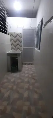a room with a hallway with a desk and a tile floor at Apartamentos LUISA in Coveñas