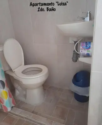 a bathroom with a toilet and a sink at Apartamentos LUISA in Coveñas
