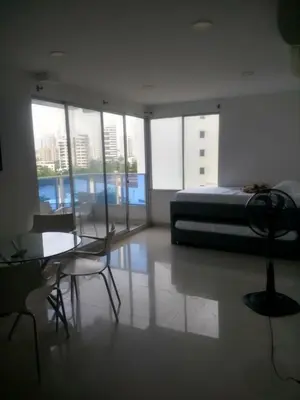 a bedroom with a bed and a table and chairs at 1C5 APARTAMENTO EN CARTAGENA CON BALCON Y VISTA AL MAR, AIRE ACONDICIONADO Y WIFi in Cartagena de Indias