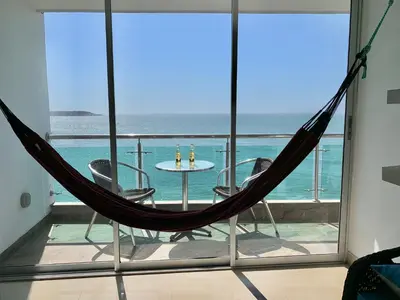 a hammock on a balcony with a view of the ocean at apartamento 807 moderno en el laguito, vista al mar in Cartagena de Indias