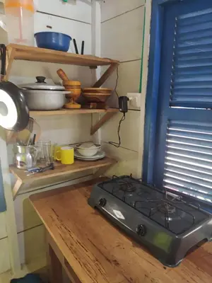 a kitchen with a stove and a wooden counter top at Rainbow Hostel in San Bernardo del Viento
